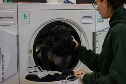 Wallpaper Mural Woman putting clothes into dryer in laundromat Torontodigital.ca