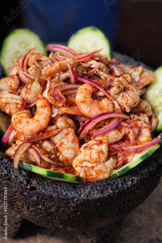 Aguachile de camarón con cebolla morada y pepino servido en molcajete