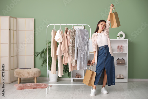 Happy young woman with shop...