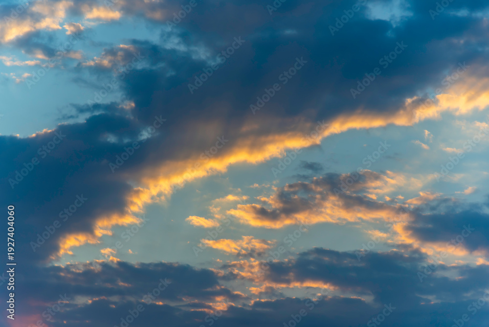 Fototapeta premium Clouds in the sunset sky A breathtaking sunset with vivid orange and yellow hues paints the sky