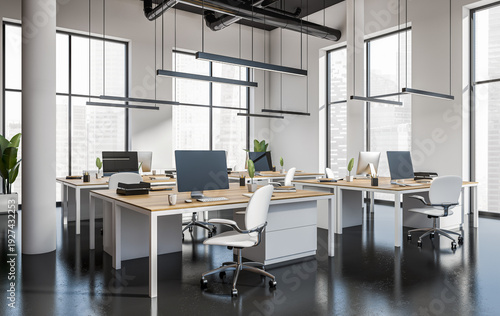Photos Open modern office interior with multiple desks and computers in clean bright st