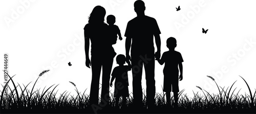 Happy family silhouette with father, mother, and three children standing in grass field at sunset, parents holding hands with kids.