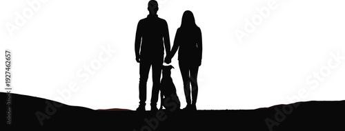Silhouette of a young couple holding hands standing with their dog on a hill during sunset for romance friendship and pet ownership