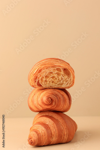 Stacked Croissant Isolated on Bright Brown Background
