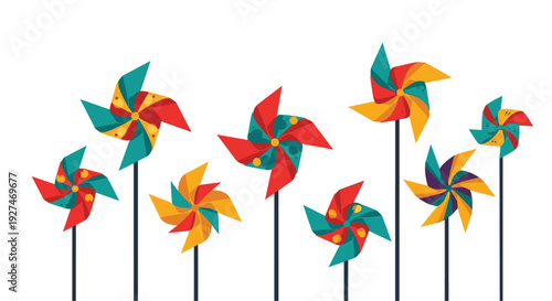 Row of vibrant multi-colored pinwheels spin on thin black sticks against plain white background creating a playful summer scene.