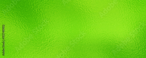 Soft Yellow green shiny Foil Texture Background with Glass Effect or sea green glass texture. bright lime green frosted foil texture with a glass-like diffusion effect. The surface has a subtle