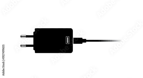Black electrical power adapter with cable on white background symbolizing energy and technology