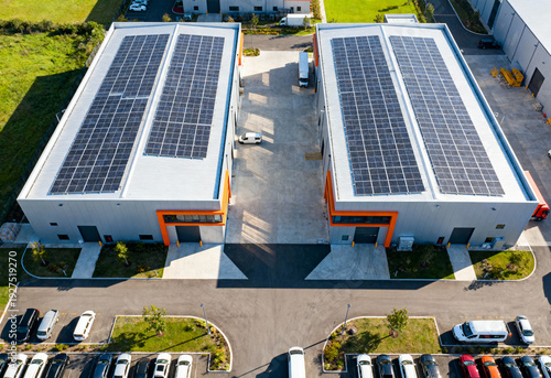 Modern industrial buildings with solar panels on rooftops for renewable energy