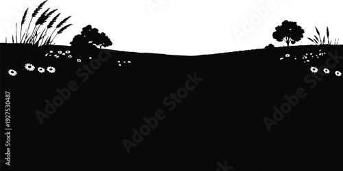 In the upper portion, the horizon line separates the dark ground from the lighter sky, establishing a clear division that enhances the sense of depth. The clusters of tall grasses and shrubs on both