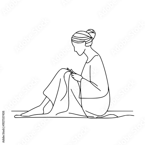 Woman Sitting Knitting on Floor with Yarn and Needles