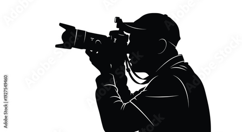 A photographer aiming a camera captured in a striking black silhouette