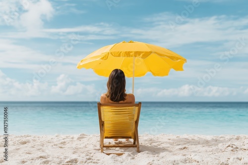 relaxing at the beach under a yellow umbrella