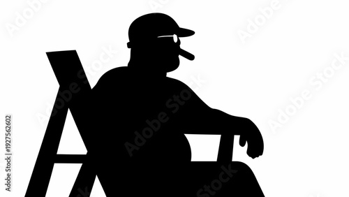 Man sitting in chair smoking cigar wearing baseball cap