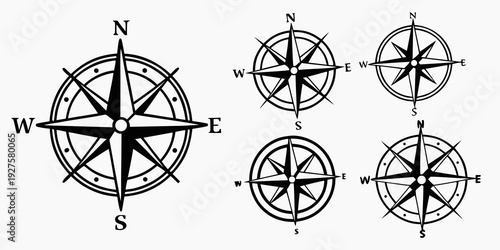 Four compasses with different orientations and a central compass indicating north. Vector