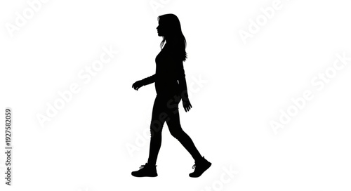 Silhouette of a young woman walking confidently.