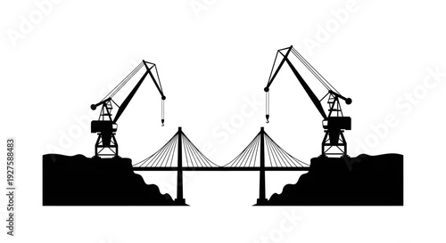 Silhouette of two industrial cranes constructing a suspension bridge over a body of water
