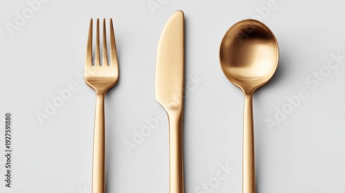 Elegant gold cutlery set including fork, knife, and spoon on a clean white background