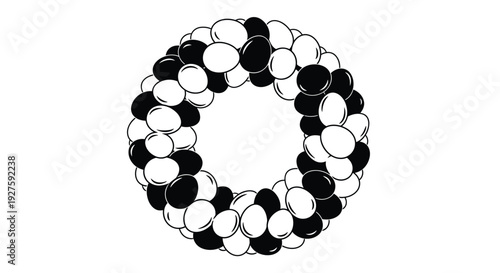 Circular arrangement of alternating black and white balloons forms a decorative wreath shape.