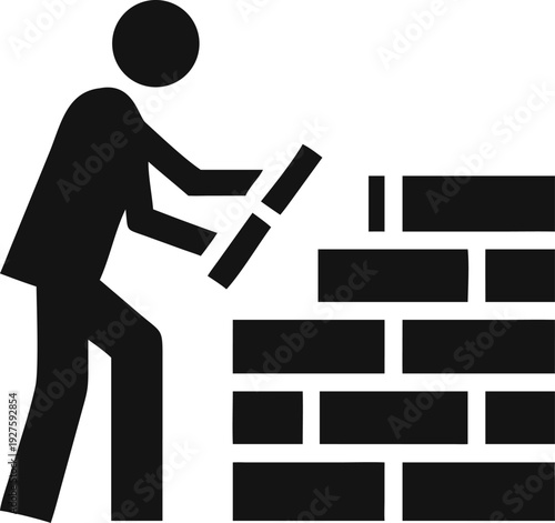 Dedicated construction worker carefully placing a new brick onto a rising wall