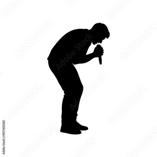 Silhouette of a man singing into a microphone.