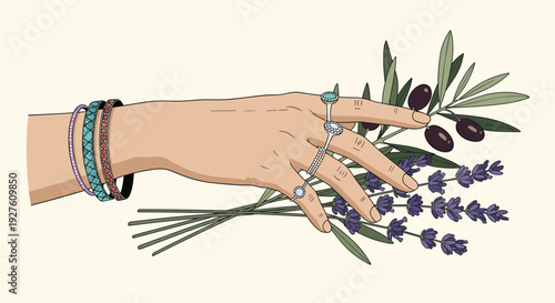 Elegant hand adorned with stylish rings and bracelets holds a bunch of fresh lavender and an olive branch with fruit.