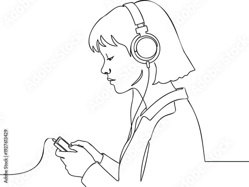 Woman wearing headphones listening to music while holding a device indoors
