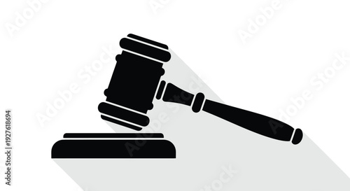 A black silhouette of a gavel resting on a soundblock casting a shadow