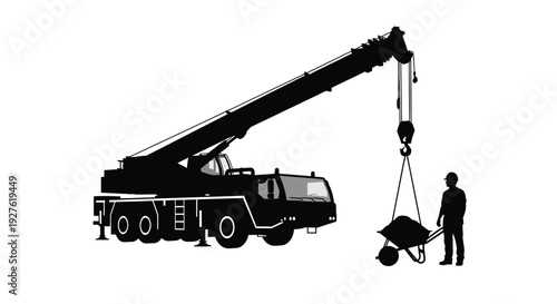 Silhouette of a mobile crane lifting a load with a construction worker