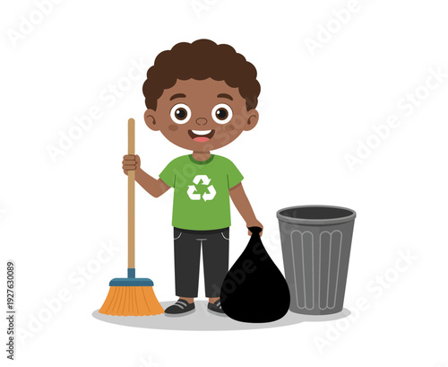 A young boy holding a trash bag and broom standing next to a recycling bin with a green recycling shirt on.