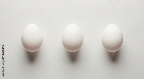 Egg-cellent Trio: An artful arrangement of three pristine, white eggs, offering a sense of simplicity and freshness.