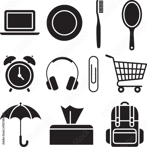 Set of black and white objects including laptop plate toothbrush alarm clock and other items