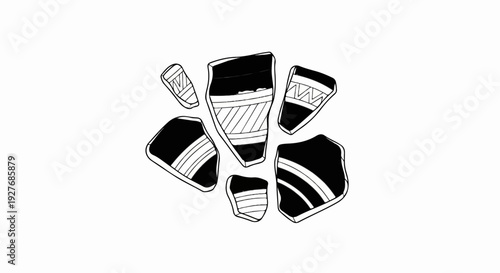 Scattered collection of ancient pottery shards with decorative patterns