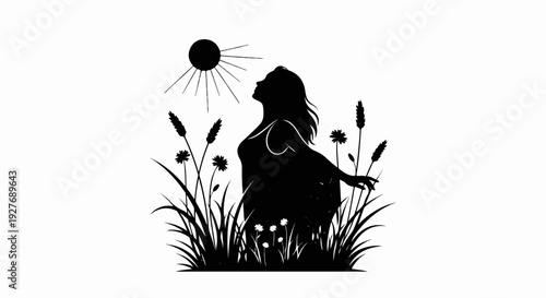 Woman in silhouette with arms outstretched in a field under the sun