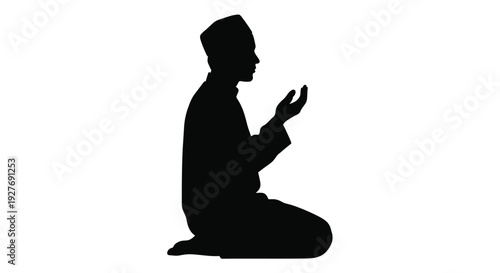 Silhouette of a man kneeling in prayer hands raised upwards