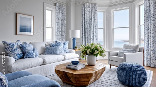 Elegant coastal living room with blue and white accents and ocean view