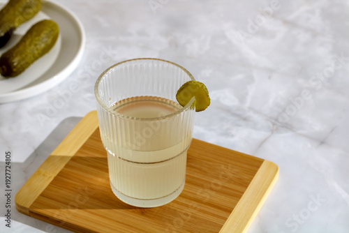 Canvas Print Fermented cucumber brine drink for electrolyte recovery in ribbed glass with pic