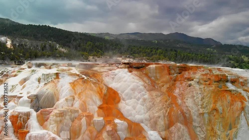 Mammoth Hot Springs, Yellowstone National Park. Aerial view of mountain and countryside. Slow motion