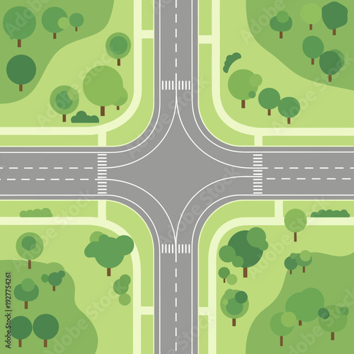 Aerial View of a Four-Way Intersection with Roads, Crosswalks, and Green Trees