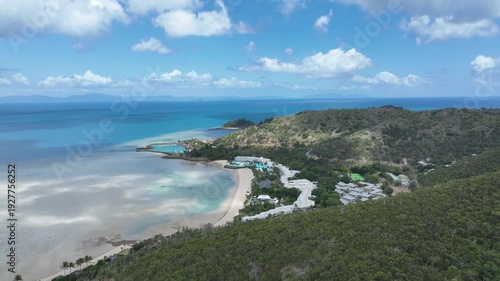Wallpaper Mural Slow drone tracking shot in daytime, moving sideways along the ridgeline to reveal Hayman Island’s curved bay, marina and turquoise Whitsundays waters, Queensland, Australia. Torontodigital.ca