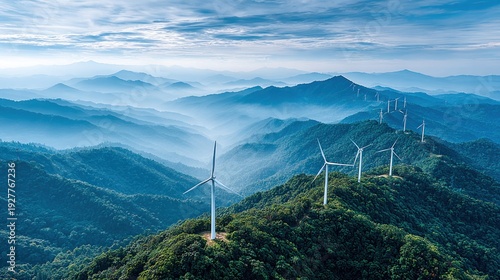 Wind turbines stand tall on a misty mountain ridge, generating clean energy for a sustainable future