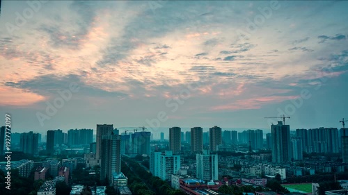 Stunning city timelapse footage capturing the transition from sunrise to sunset, with golden hour light, dramatic clouds, and city lights illuminating the urban skyline in 4K.