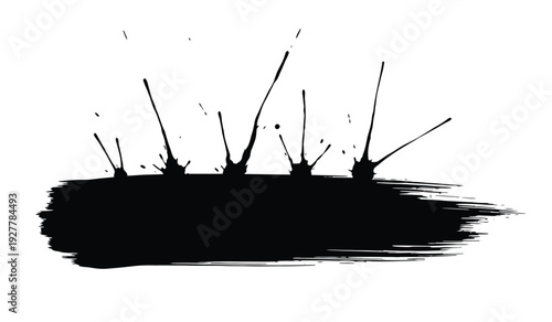 Black paint splatter on a with dynamic brush strokes and ink splashes creating a messy artistic effect
