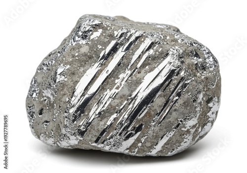 A close-up view of a rough, silver metal ore specimen on a plain surface