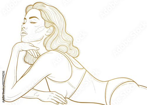 Woman lying on her stomach with her hand under her chin in a relaxed pose