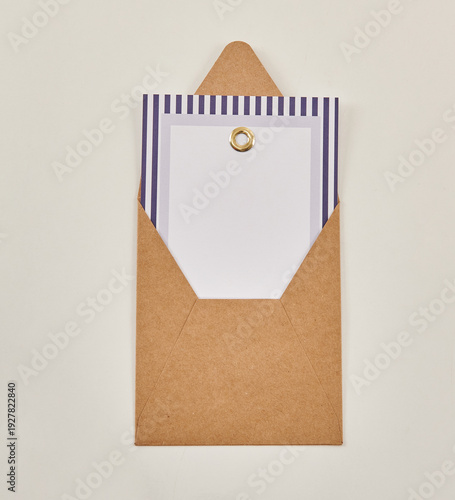 Beautiful floral arrangements: a hand-held bouquet of orange and white roses, and a pink tulip arrangement in a decorative striped box against a white brick wall.