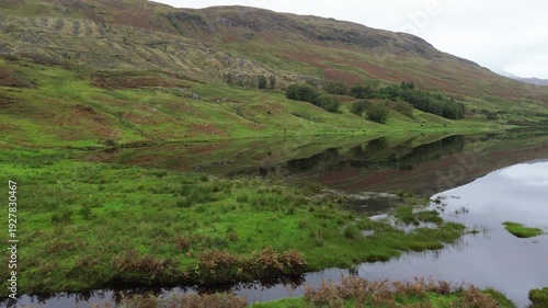 Amazing drone video over Loch Lugnaig, near Ardchullarie More, Scotland, taken during a lovely autumn day while roadtripping along Scottish countryside.