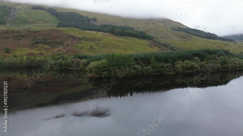 Amazing drone video over Loch Lugnaig, near Ardchullarie More, Scotland, taken during a lovely autumn day while roadtripping along Scottish countryside.