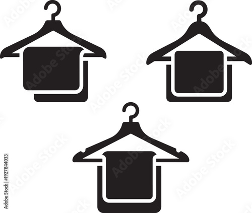Three black hangers with folded clothes, suggesting fashion, retail, storage, and laundry services.