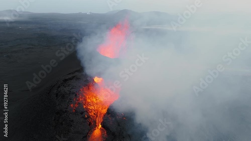 Wallpaper Mural Volcanic eruption glowing lava flow streaming from crater, dramatic smoke and fire, raw natural phenomenon in Iceland Torontodigital.ca