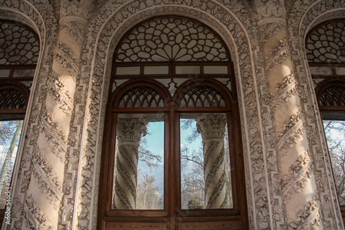 Wallpaper Mural Wooden entrance door with plastered facade around it, and a reflection of the outside space in the door Torontodigital.ca